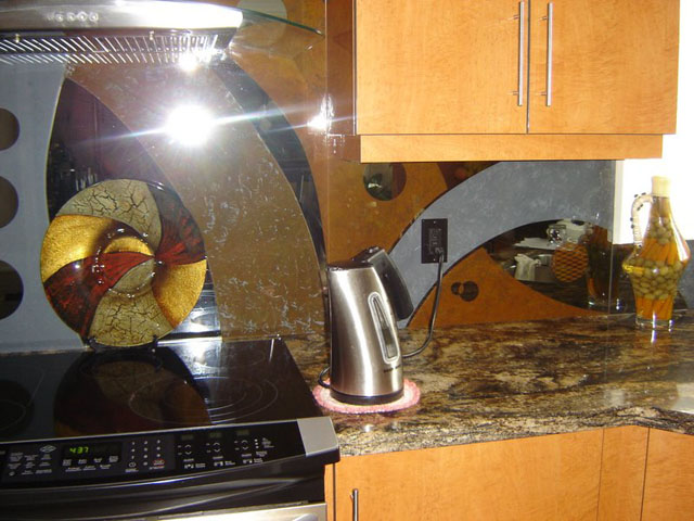 Art work on gray mirror kitchen backsplash