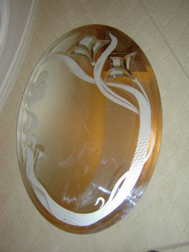 Beveled oval mirror with design
