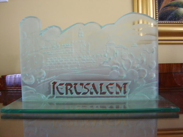 Deep carved glass artwork on base