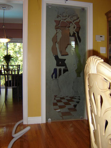 Artistic glass between kitchen and dining room